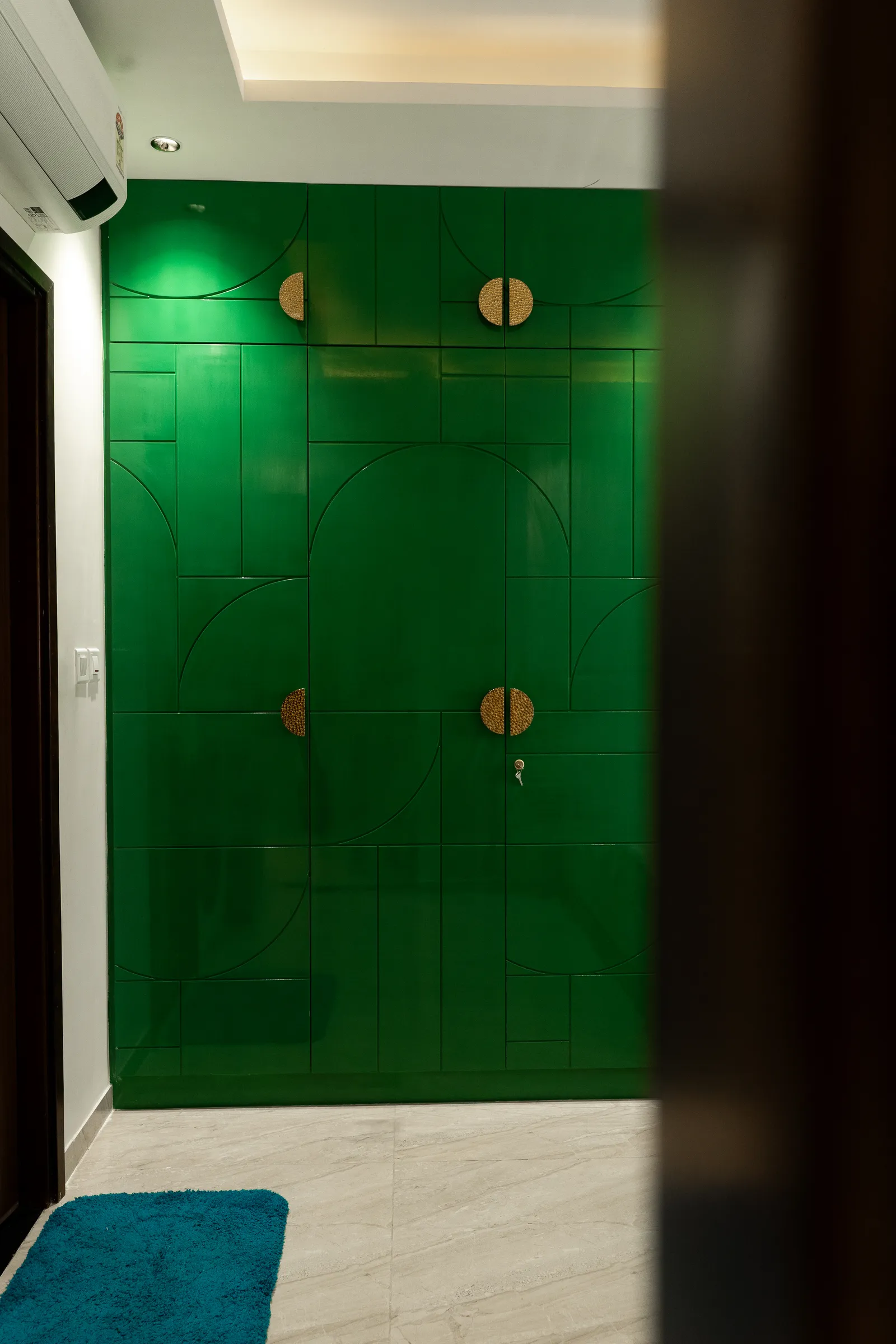 Emerald-green wardrobe with brass circular handles — Arna's Home